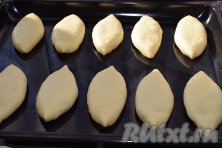 Противень смазываем растительным маслом и выкладываем получившиеся пирожки швом вниз.

