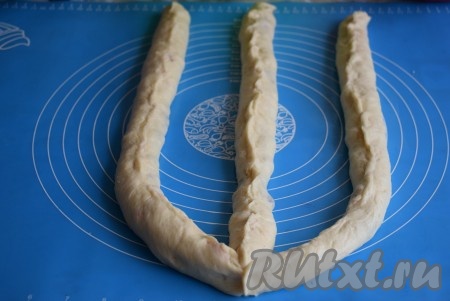 Подготовленные трубочки скрепляем с одного края и начинаем плести косичку, перекидывая жгутики между собой.
