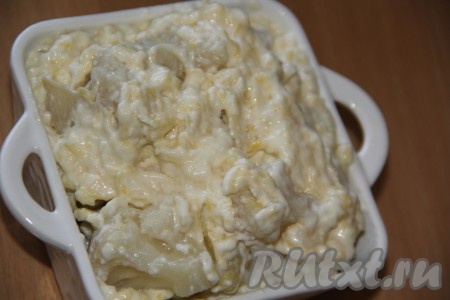 Затем снять сырный соус с огня и выложить в него цветную капусту, разобранную на соцветия. Я готовила с замороженной цветной капустой и предварительно её не размораживала (если готовите со свежей цветной капустой - её не нужно предварительно отваривать). Перемешать капусту с соусом и выложить в жаропрочную форму. Я дно и бока формы предварительно смазала сливочным маслом.