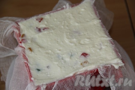 Выложить получившуюся творожную массу в форму для пасхи, застеленную марлей в два слоя (края марли должны свисать с краёв формы).
