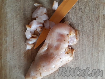 Куриную грудку посолить, поперчить, натереть специями для курицы. Оставить на час для маринования. Затем филе нарезать небольшими кубиками и обжарить на растительном масле на среднем огне до золотистого цвета со всех сторон. 
