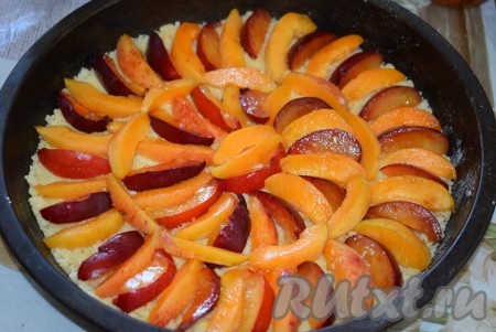 На тесто выкладываем дольки абрикосов и слив.
