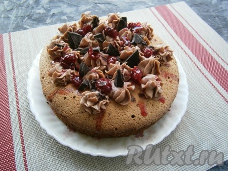 Дать бисквиту немного остыть и вынуть его из формы, а далее полностью остудить на решётке. Остывший бисквит можно использовать для формирования торта или просто посыпать сахарной пудрой и подать к вечернему чаю. Я украсила бисквит шоколадным кремом, вишней, кусочками шоколада и сахарной пудрой.