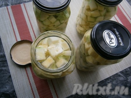 Залить нарезанные кабачки кипящей водой, накрыть банки прокипячёнными крышками и оставить на 15 минут.
