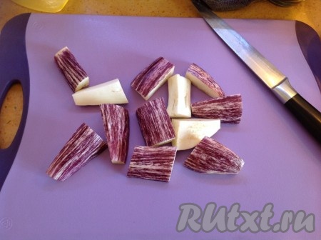 Отрезать хвостики у баклажанов и нарезать их вдоль на крупные кусочки.