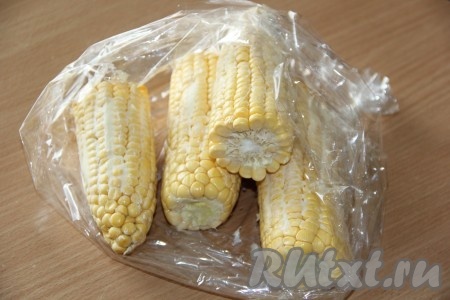Кукурузу смазать мягким сливочным маслом со всех сторон и выложить в рукав для запекания.
