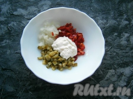 В отдельную посуду выложить очищенный и нарезанный мелко лук, а также нарезанные мелкими кубиками маринованный огурец и болгарский сладкий перец, добавить майонез.
