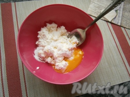 Яйцо разделить на желток и белок (желток добавим в тесто, а белок будем использовать для смазывания коржиков). В отдельную посуду выложить желток, добавить к нему творог и всыпать сахарную пудру, тщательно перемешать, чтобы не было крупных комочков творога.
