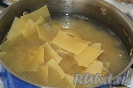Бульон посолить по вкусу, дать ему закипеть. Выложить в кипящий бульон лапшу.
