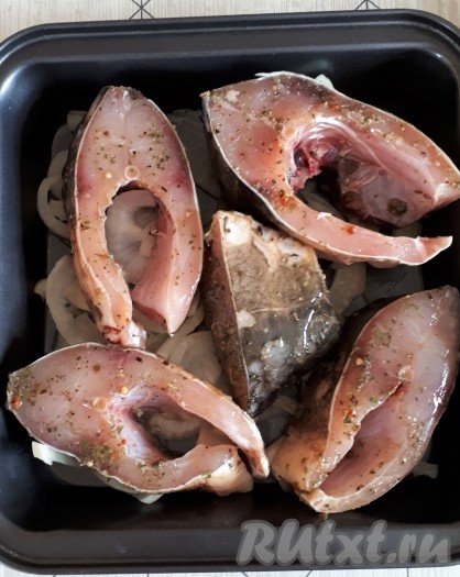 Поверх лука разместить кусочки карпа.
