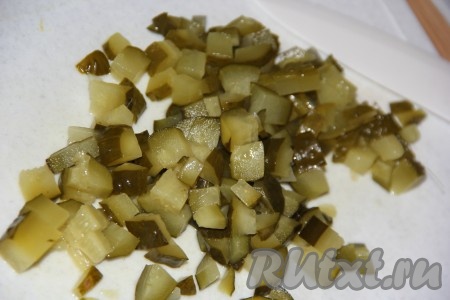 По прошествии 10 минут в суп с курицей и картошкой выложить огурцы, нарезанные на кубики, варить 10 минут.
