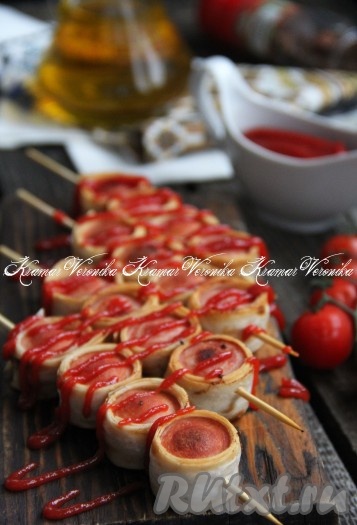 Аппетитные, вкусные жареные сосиски в лаваше на шпажках переложить со сковороды на тарелку и в горячем виде подать к столу, дополнив соусом.
