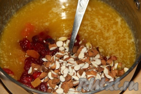 Орехи крупно порубить (я взяла миндаль). Сухофрукты (я взяла вишню и курагу) нарезать на кусочки. Снять кастрюлю с огня и сразу добавить орехи и сухофрукты, перемешать ложкой.

