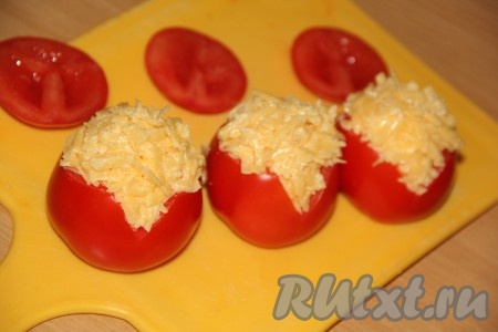 На стенке каждого помидора вырезать небольшой треугольник, который нужен для того, чтобы борода "Деда Мороза" из майонеза не стекала по гладкой поверхности помидора. Наполнить помидоры начинкой. Сверху помидоров должна быть пышная шапка из начинки.