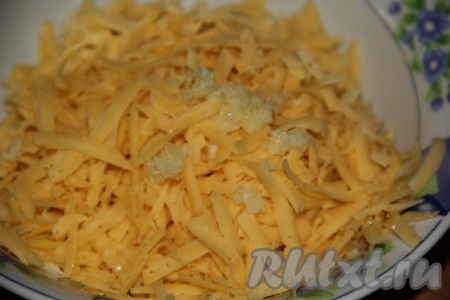 К натёртому сыру добавить очищенный и пропущенный через пресс чеснок.
