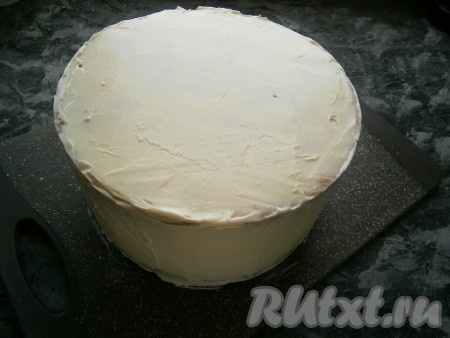 Частью ганаша покрыть и выровнять охлаждённый торт (это будет черновой слой), поместить торт в холодильник минут на 20-30. Затем покрыть и выровнять торт основным слоем ганаша. Мне слишком выравнивать торт не было смысла, так как бока будут покрыты крошкой, а верх будет украшен кремом. Можно ганаш и не использовать, но с ним торт держится плотнее, не потечет крем, торт можно транспортировать и т.д.
