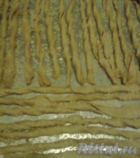 Смочить спиральки слегка водой с помощью кисточки, посыпать кунжутом и натёртым твёрдым сыром или любимыми приправами (розмарин, тмин, прованские травы).
