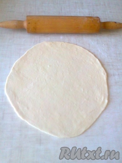 Возьмите один шар и на столе, припылённом мукой, с помощью скалки раскатайте в круг толщиной около 2-3 мм.