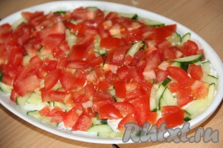 Помидор мелко нарезать и выложить половину нарезанного помидора поверх огурца (вторую половину помидора оставить для украшения салата), можно слегка посолить.
