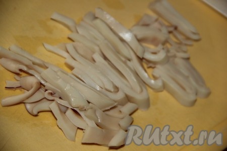 Затем нарезать кальмаров на тонкие полоски.
