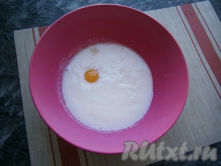 В кефир комнатной температуры всыпать соду, перемешать и оставить на 5-6 минут (сода за это время погасится в кефире). Затем добавить сырое яйцо, соль и сахар.
