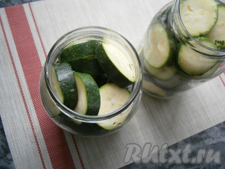 Нарезать кабачки на кружочки шириной, приблизительно, 1 см и наполнить ими банки.
