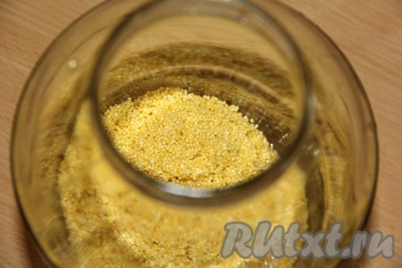 В чистую трёхлитровую банку выложить пшено.
