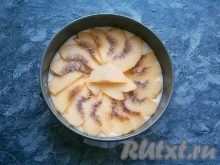 Дно разъёмной формы диаметром 18 см застелить пергаментом, выложить подготовленное тесто. На тесто немного внахлёст выложить персики, нарезанные тонкими дольками. Посыпать персики сахаром (если персики очень сладкие - можете этого не делать).