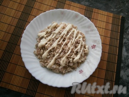 Следующим слоем выложить куриное мясо и нанести сверху майонез в виде сеточки.
