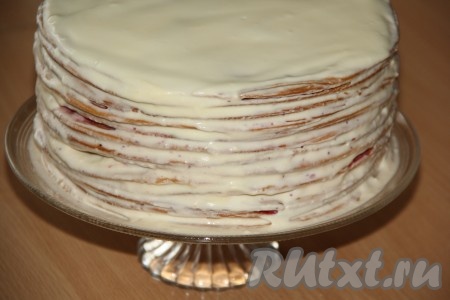 Медовик с клюквой смазать сверху и с боков кремом из сгущёнки, масла и сметаны.
