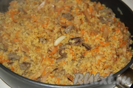 Во время готовки блюдо перемешивать не нужно. Жидкость должна полностью испариться. Снять сковороду с огня и оставить под крышкой на 10 минут. Затем перемешать булгур с сердечками.
