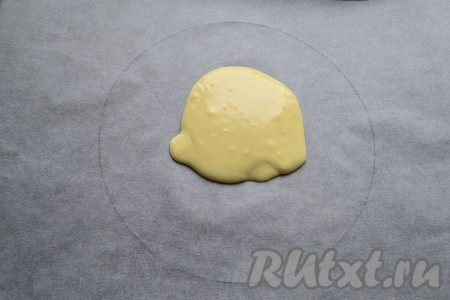 Взять лист пергамента размером с противень, начертить на нём круг диаметром 20-22 см, перевернуть. В центр круга выложить 4-5 столовых ложек теста.
