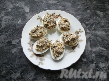 Желтково-грибной массой наполнить яичные белки.