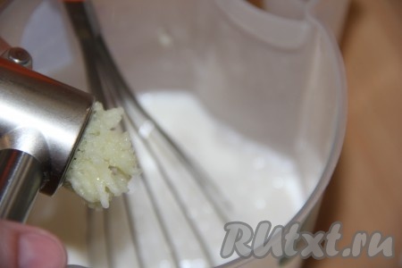 В получившийся сметанный соус добавить 2 очищенных зубчика чеснока, пропущенных через пресс, перемешать, слегка посолить.
