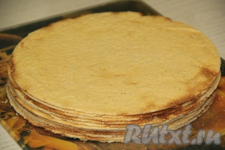 Обрезки складывать отдельно, они нам потребуются для обсыпки торта. Таким образом испечь все коржи. Коржи сложить друг на друга и остудить.