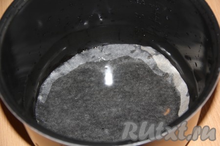 Дно мультиварки выстелить пергаментом и влить растительное масло.
