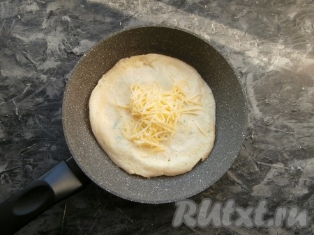 Жарить яичный блинчик на среднем огне, приблизительно, 1-2 минуты, после чего, перевернуть на другую сторону. В центр блинчика выложить хорошую щепотку натёртого на средней тёрке сыра.
