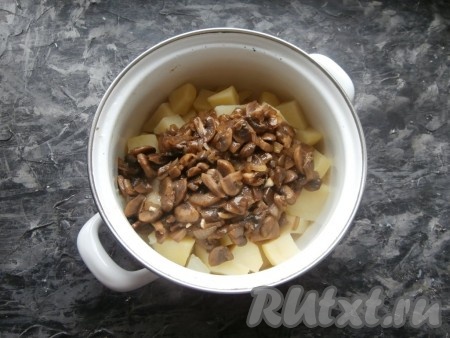 Дать маслу полностью растопиться, перемешать и подержать сковороду на огне ещё несколько минут. Жареные грибы выложить в кастрюлю с варёной картошкой.
