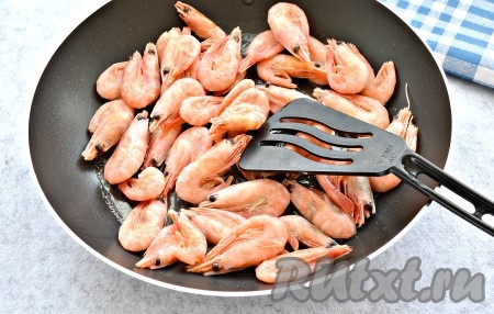 В сковороде растопить сливочное масло. Выложить креветки.
