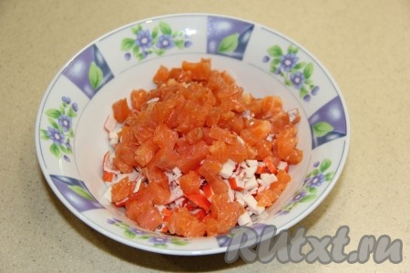 Красную рыбку тоже мелко нарезать и соединить с крабовыми палочками, перемешать.
