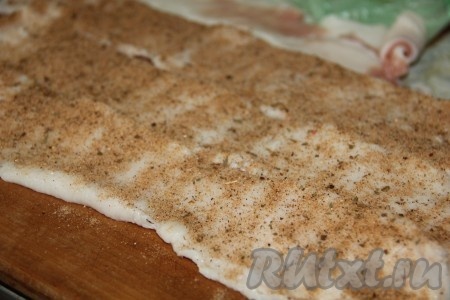 Сало выкладываем на доску, солим и добавляем специи для сала. Хорошенько втираем руками специи.