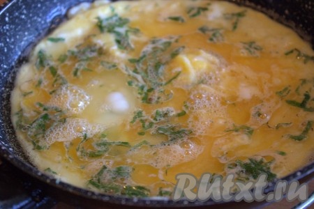 В хорошо разогретую сковороду влить 1-2 столовые ложки растительного масла, добавить яичную смесь, распределяя её равномерно по дну сковороды. Яичный блинчик жарить на среднем огне с двух сторон до золотистого цвета (минуты по 2 с каждой стороны).