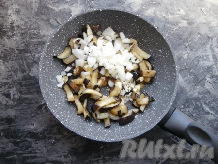 По прошествии времени отжать баклажаны от лишней жидкости и переложить в сковороду, уже хорошо разогретую с растительным маслом, обжарить их на среднем огне, помешивая, до лёгкой румяности и готовности (около 7-10 минут). После этого добавить измельчённый чеснок и мелко нарезанный лук.