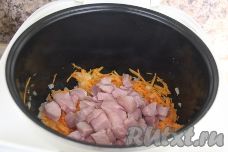 Свинину (я использовала мякоть свинины без жирка) нарезать на кубики размером, примерно, 2 см на 3 см и выложить к уже обжаренным овощам. Мясо с луком и морковкой обжаривать около 5 минут, не забывая помешивать.