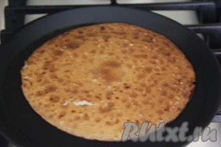 Выпекать блин с двух сторон до золотистого цвета на умеренном огне, затем переложить на тарелку, а из оставшегося теста один за другим пожарить все блинчики. Если выпекать на сковороде диаметром 18 см, получится 25-28 блинов.