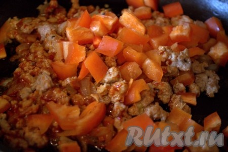 Затем болгарский перец выложить в сковороду к луку с чесноком и фаршу, помешивая, обжаривать 5-7 минут на среднем огне.