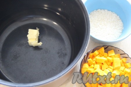 Нарезать на средние кубики 200 грамм очищенной тыквы. В чашу мультиварки выложить 10 грамм сливочного масла.