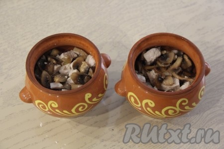 Разложить грибы с куриным мясом по горшочкам. У меня получилось 2 горшочка объёмом 400 мл.