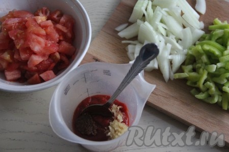 В высокой чаше соединить томатную пасту, измельчённый чеснок, аджику, соль и паприку.