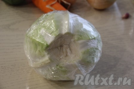 У кочана капусты вырезать кочерыжку. Теперь нужно размягчить листы капусты. Для размягчения можно поместить кочан в глубокую кастрюлю, затем залить его водой так, чтобы она немного покрывала капусту, отправить на огонь, после закипания проварить 4-5 минут, затем достать кочан, мягкие листы отделить от кочана, а оставшиеся листья поместить в ту же воду и отварить до мягкости. Я решила размягчить капустные листы в микроволновке - это намного быстрее, чем варить в кастрюле, для этого выложить кочан в полиэтиленовый пакет (или обернуть его в пищевую плёнку), поместить в микроволновку и готовить на максимальной мощности минут 10, затем развернуть плёнку и снять размягчившиеся листики капусты.
